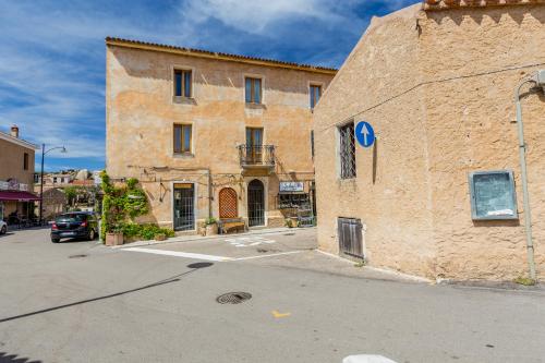 a large brick building on the side of a street at Palazzo Beddoro in San Pantaleo