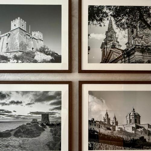 four pictures of buildings are hanging on a wall at Palazzo De La Sengle Boutique Hotel in Senglea