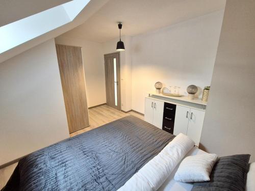 a bedroom with a large bed in a room at Tranquille Inn Apartments in Kysucké Nové Mesto