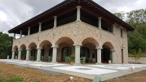 a large brick building with arches on it at Agriturismo Grammelot in Sarnico