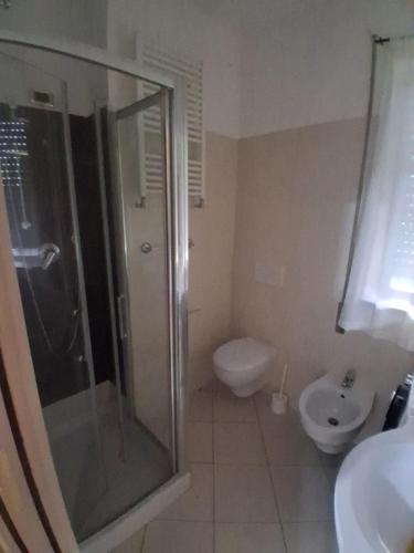 a bathroom with a shower and a toilet and a sink at Onda Blu in Marina di Vasto