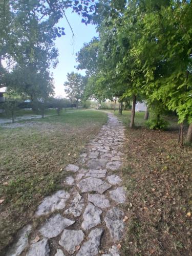 a stone path in a park with trees at Onda Blu in Marina di Vasto