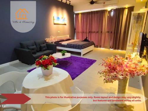 a living room with a couch and a table with flowers at AeroRest Suites - Kota Warisan in Sepang