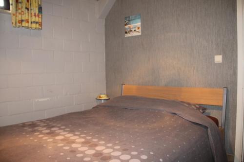a bedroom with a bed with a brown blanket on it at Hof Ter Hagen in Lokeren