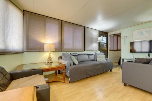 a living room with a couch and a tv at Pool and Hot Tub Access Home in Jensen Beach! in Jensen Beach