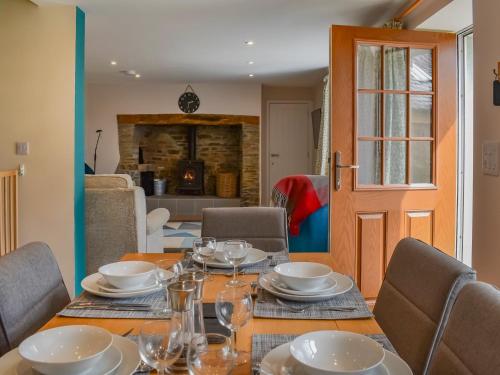 a table with plates and glasses on top of it at Uk47757 - Rose Cottage in Launceston