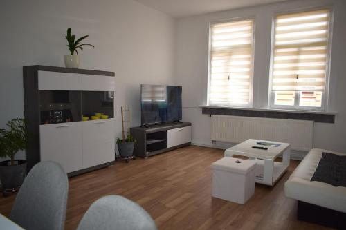 a living room with a couch and a tv at Ferienwohnung in Gotha in Gotha