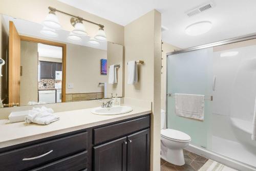 a bathroom with a sink and a toilet and a shower at Cozy Timbers - Charming Condo for 6 with Resort-style Amenities in Branson