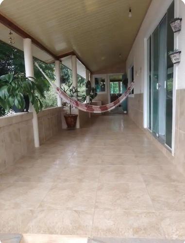 a porch of a house with a hammock on it at Descanso merecido in Morretes