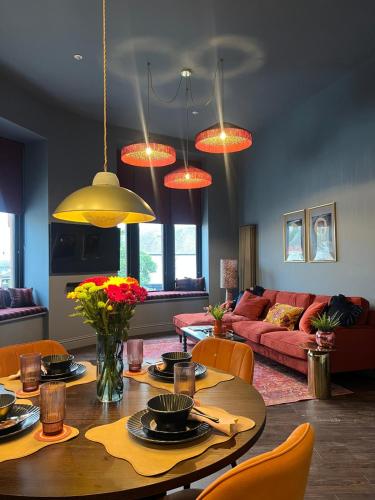a living room with a table and a couch at The Bank - Rooms & Apartments by Coorie Doon Stays in Troon
