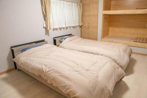 two beds in a small room with a window at Komorebi no Yado - Vacation STAY 19011v in Goto