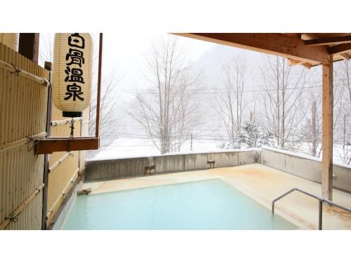 a swimming pool in the snow with a sign at Ebisuya - Vacation STAY 31583v in Hirayu