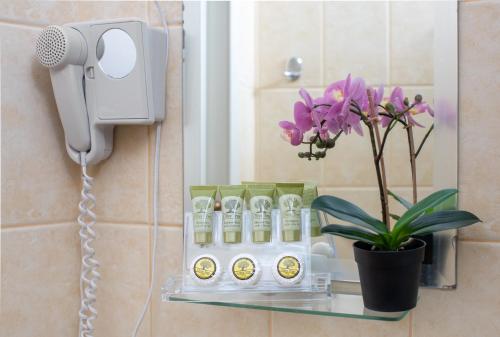 a phone on a wall next to a shelf with products at Seaside apartments in Alikí