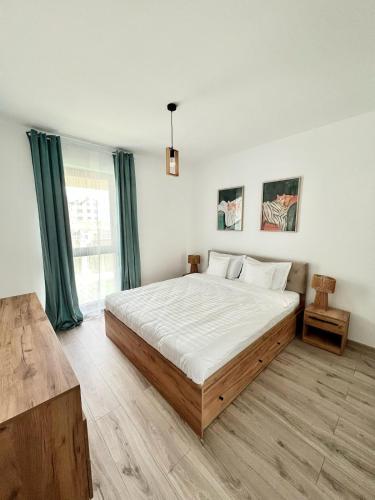 a bedroom with a large bed and a large window at SeaTok & Stay in Costinesti