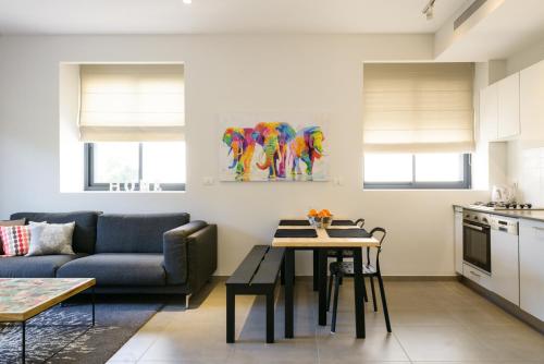 a living room with a couch and a table at Sunny Luxury Apartments in Tel Aviv