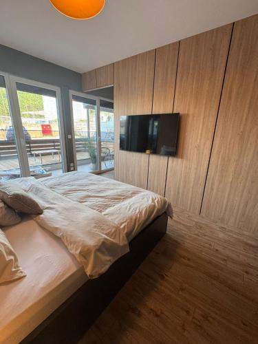 a bedroom with a bed and a flat screen tv at AD Luxe Lake Suite in Ohrid