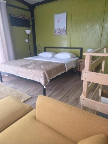 two beds in a room with green walls at Milosev Konak in Aleksandrovac