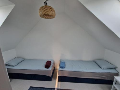 two twin beds in a room with a lamp at La Jura in Podlesice