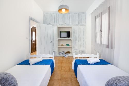 a room with two beds and a tv at Lindos Diamond Exclusive Villa in Líndos