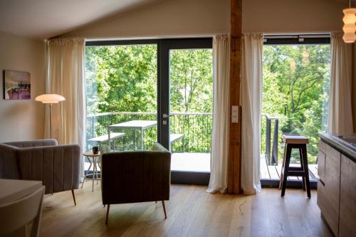 a living room with a large sliding glass door at Fewo im Naturschutzgebiet, mit großem Balkon in Templin