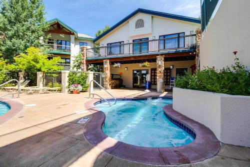 a house with a swimming pool in a yard at Storm Meadows Slopeside Retreat in Steamboat Springs