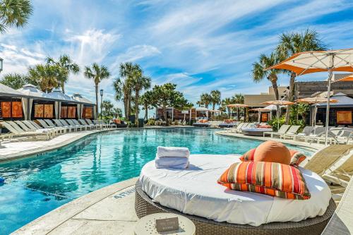a swimming pool with a bed in front of a resort at San Luis Getaway #435 by Vacasa in Galveston