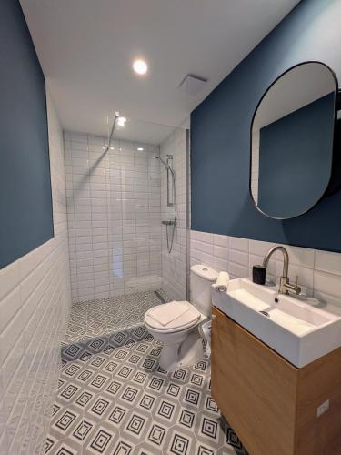 a bathroom with a toilet and a sink and a mirror at mg4 Apartments in Murau