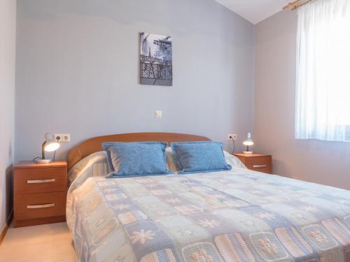 a bedroom with a large bed with blue pillows at Apartments Masek in Poreč