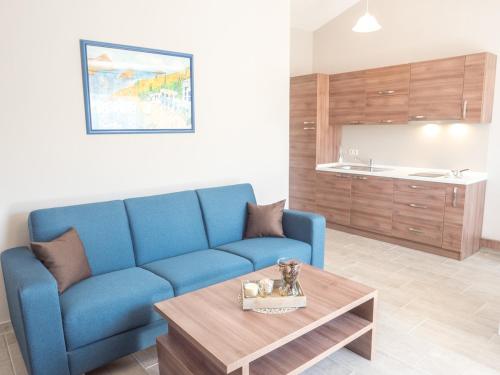 a living room with a blue couch and a coffee table at Apartments Masek in Poreč
