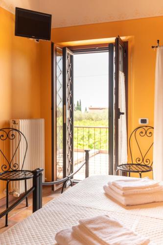 a bedroom with a bed and a sliding glass door at B&B Casale Ansamagi Relax & Pool in Genzano di Roma