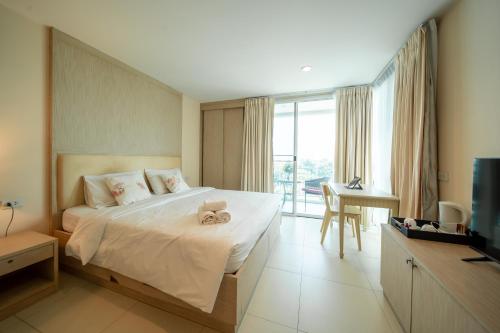 Ένα ή περισσότερα κρεβάτια σε δωμάτιο στο Shamrock Hotel Pattaya