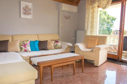 a living room with two couches and a coffee table at Apartments Masek in Poreč