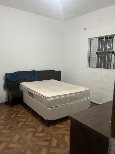 a bedroom with a bed in a room with a window at Espaço laser soberana in Guarulhos