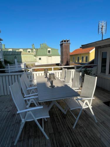 a wooden table and chairs on a deck at Marstrand in Marstrand