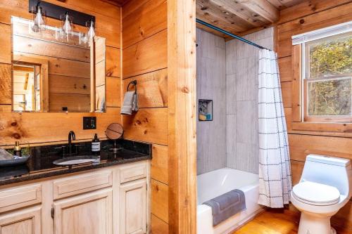 a bathroom with a toilet and a sink and a tub at Private Getaway, Arcade Game, Hot Tub & Fire Pit in Townsend