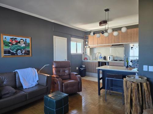 a living room with a couch and a table in a kitchen at APTO 1004 Ed PEQUENO PRÍNCIPE in Uruguaiana