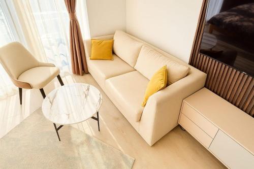 a living room with a couch and a glass table at Voli Central point in Sutomore