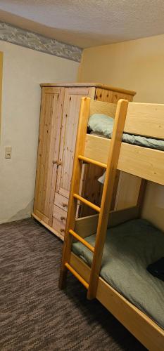 a bunk bed in a room with a ladder at Ferienhaus Anna in Weitenbach