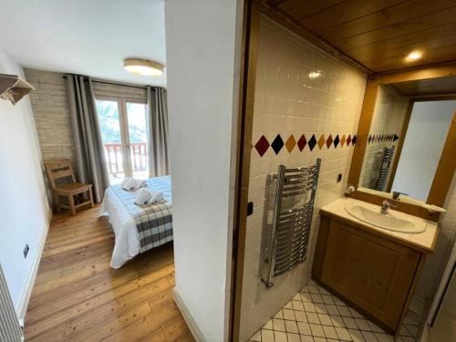 La salle de bains est pourvue d'un lavabo et d'un lit dans la chambre. dans l'établissement Les Chalets Du Gypse - LES CHALETS DU GYPSE C14 MAE-3671, à Saint-Martin-de-Belleville