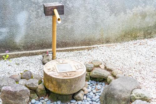 a rock garden with a birdbath in the middle at Sanada Maru in Kaizuka