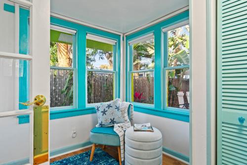 a blue room with a chair and windows at The Love Shacks in Lake Worth