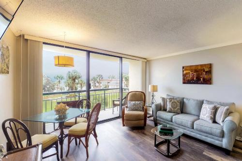 a living room with a couch and a table at San Luis Getaway #435 by Vacasa in Galveston