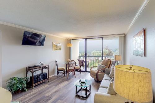 a living room with a couch and a table at San Luis Getaway #435 by Vacasa in Galveston