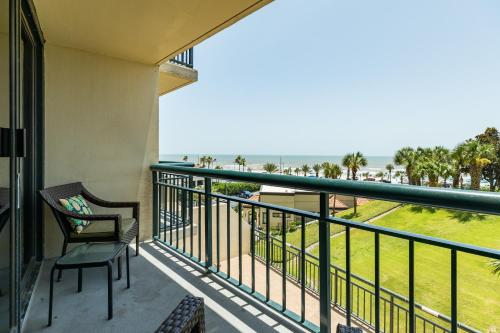 a balcony with a chair and a view of the ocean at San Luis Getaway #435 by Vacasa in Galveston