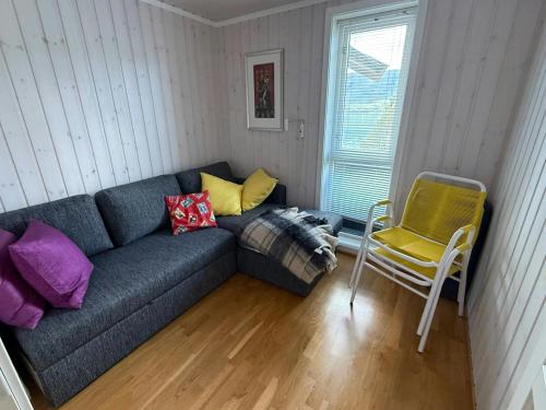 a living room with a couch and a chair at Seaside Cabin With Private Pier In Eidsvåg in Eidsvåg