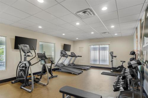 a gym with several treadmills and elliptical machines at Best Western Plus Hershey in Hershey