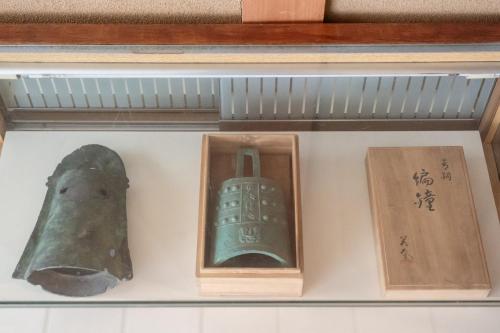a shelf with three different types of artifacts on it at Sanada Maru in Kaizuka