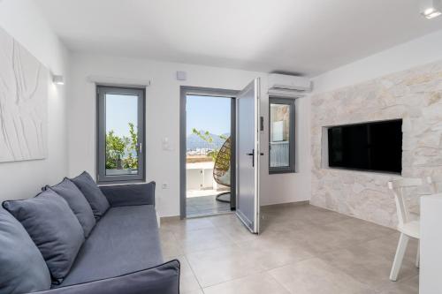 a living room with a couch and a tv at CASA ANNA BOUTIQUE SUITE Apartment New in Adamas