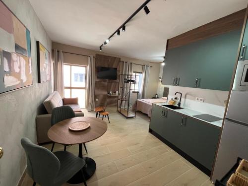 a kitchen and a living room with a table in a room at CORNELIAS HOME Estudio 5B in Los Cristianos