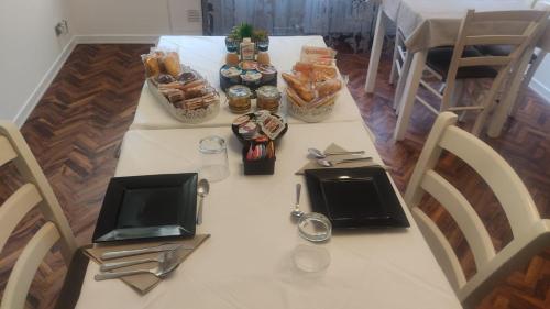 a white table with food and snacks on it at B&B Lary in Pescara